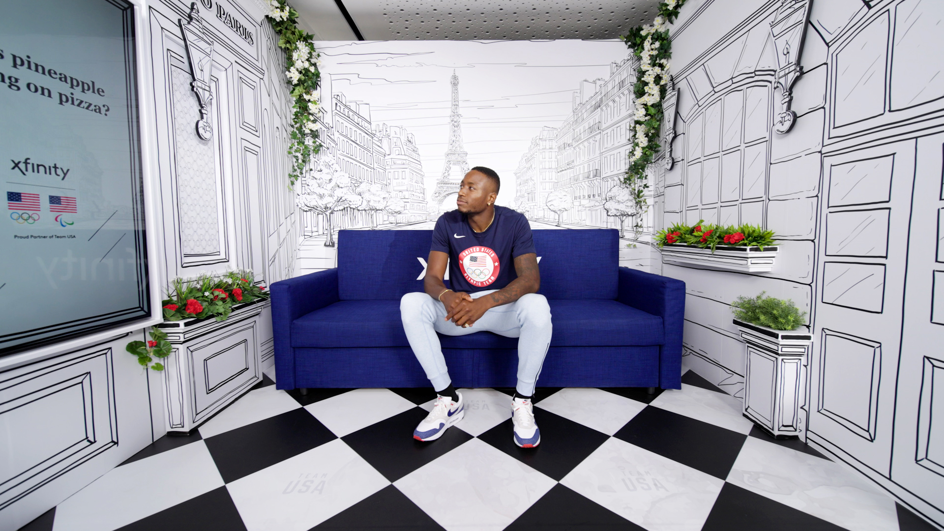 Centered view of Team USA athlete on Xfinity couch.
